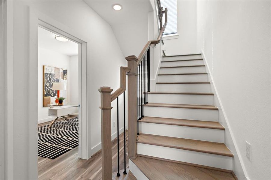 Inviting staircase, lead you up to the living area of your beautiful new home. You can see the downstairs bedroom and full bath to your left.