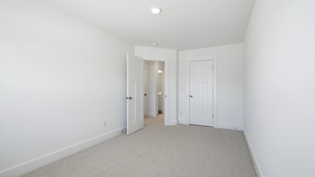 Vibrant and inviting secondary bedroom featuring a walk-in closet and refined finishes near Downtown Fountain Inn Vibrant and inviting secondary bedroom featuring a walk-in closet and refined finishes near Downtown Fountain Inn