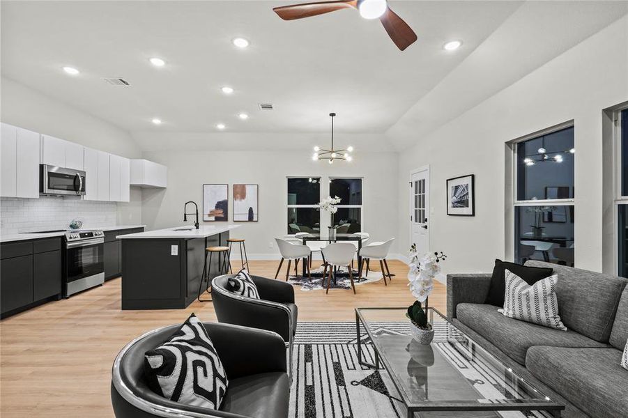 Living room with sink, light hardwood / wood-style floors, and ceiling fan with notable chandelier