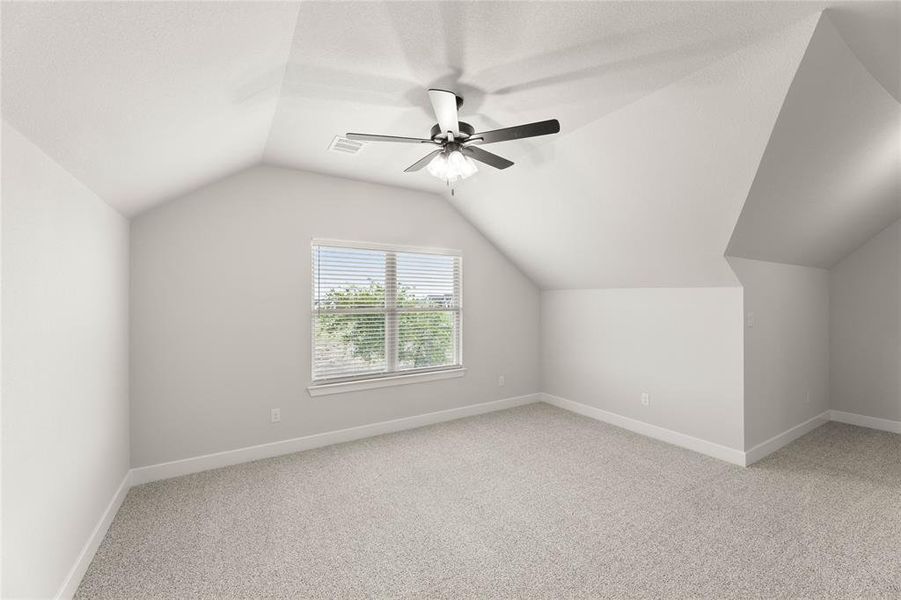 Bonus room featuring light colored carpet, lofted ceiling, and ceiling fan Bonus room featuring light colored carpet, lofted ceiling, and ceiling fan