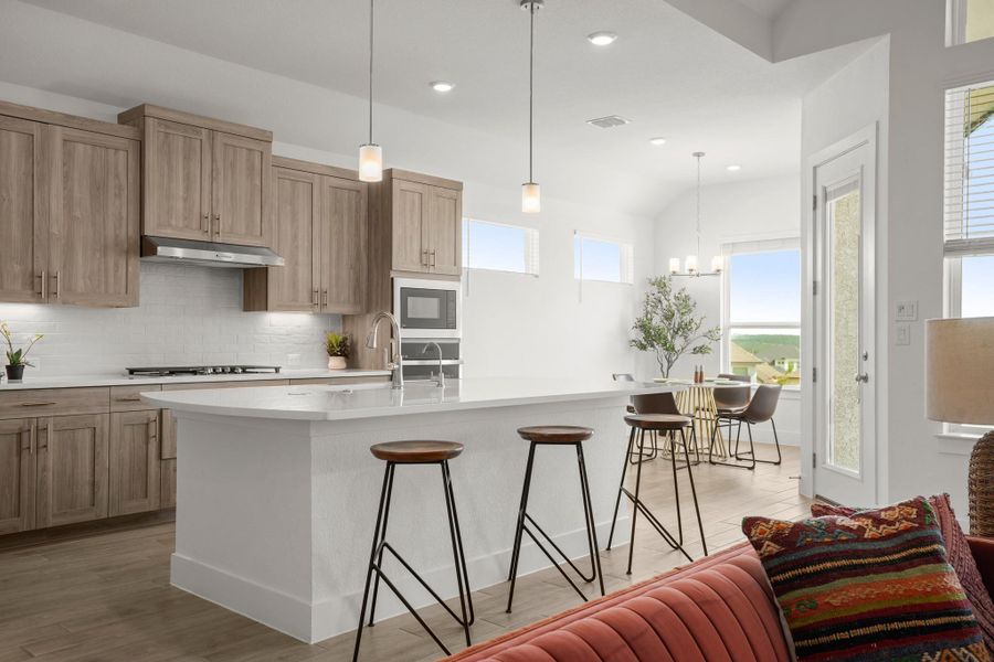 Culinary delights await in this bright kitchen with a spacious island, seamlessly flowing into a dining area.