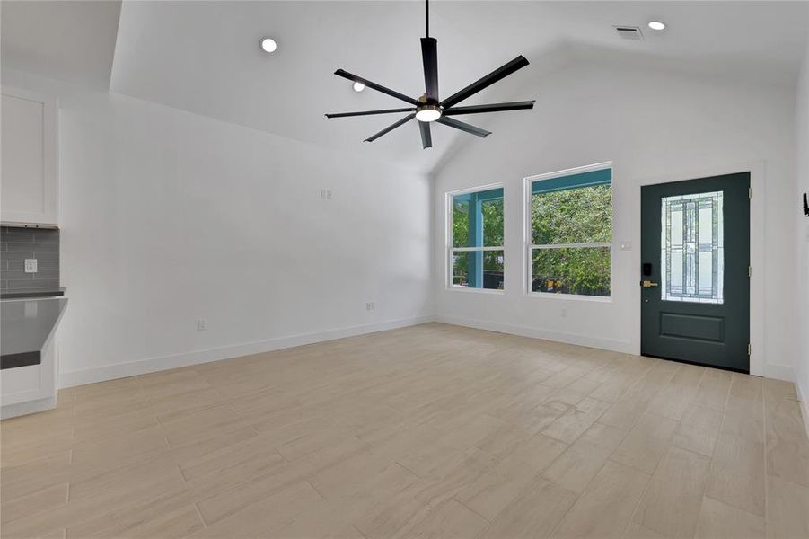 The living area has cathedral ceilings with industrial style ceiling fan