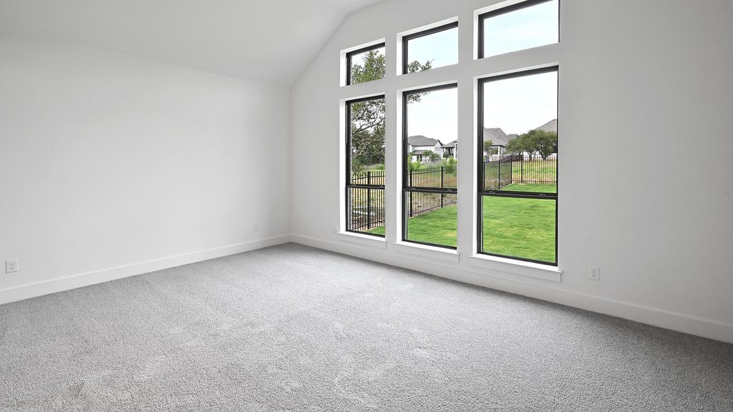 Spare room featuring carpet flooring, baseboards, and high vaulted ceiling Spare room featuring carpet flooring, baseboards, and high vaulted ceiling
