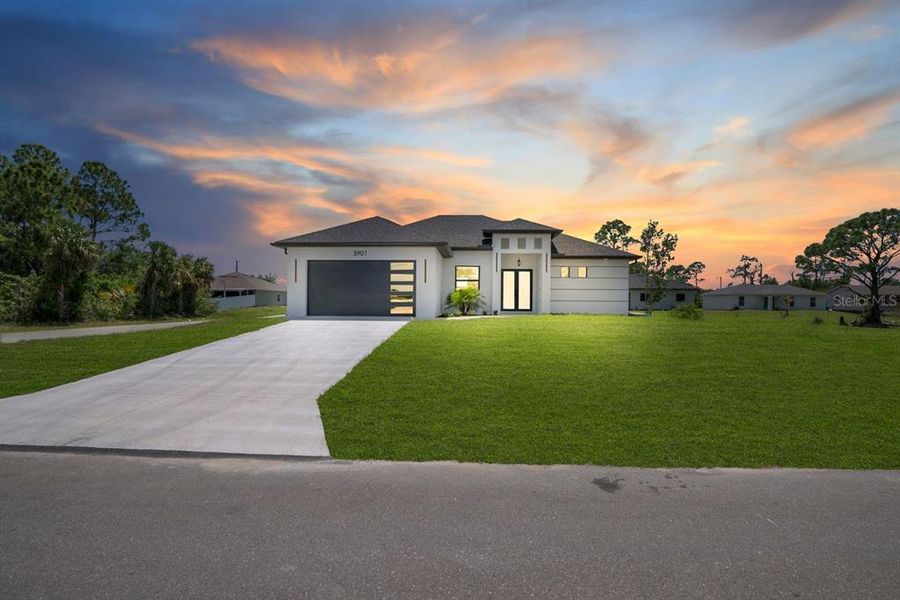 Front exterior of a new home in , Lehigh Acres, FL, highlighting curb appeal (Image 21).