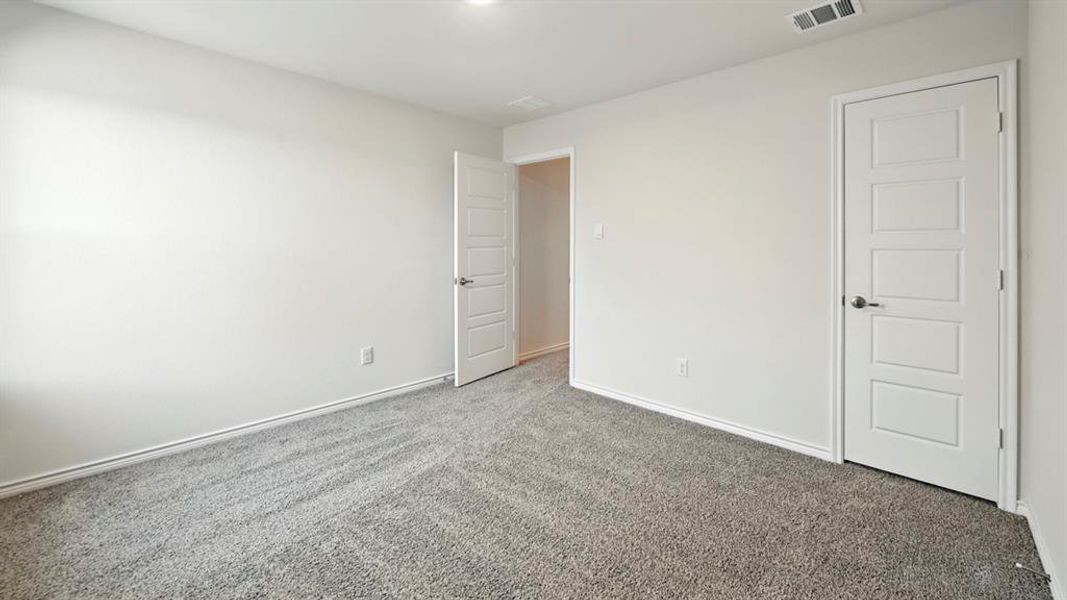Unfurnished bedroom featuring carpet and baseboards