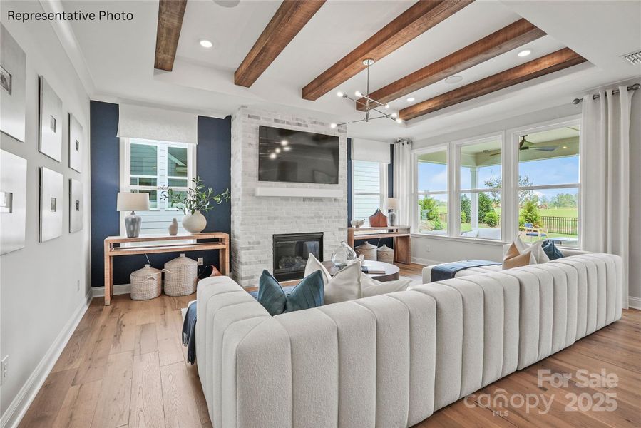 Bright gathering room features a tray ceiling and gas fireplace Bright gathering room features a tray ceiling and gas fireplace