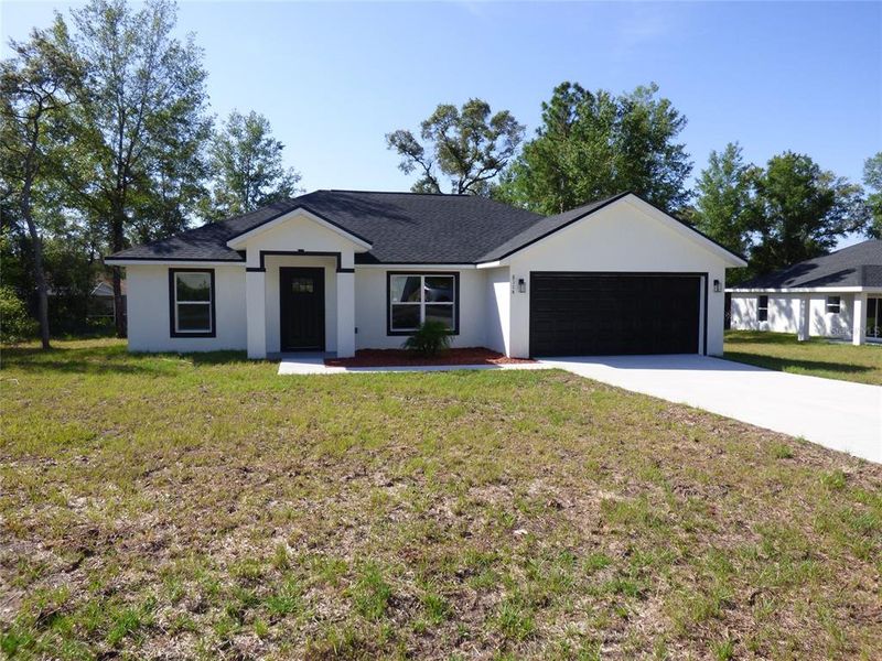 Front exterior of a new home in , Citrus Springs, FL, highlighting curb appeal (Image 1). Front exterior of a new home in , Citrus Springs, FL, highlighting curb appeal (Image 1).