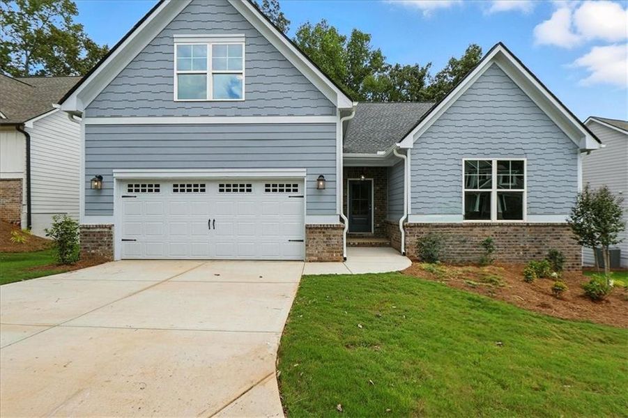 Front exterior of a new home in Traditions of Braselton, Jefferson, GA, highlighting curb appeal (Image 22). Front exterior of a new home in Traditions of Braselton, Jefferson, GA, highlighting curb appeal (Image 22).