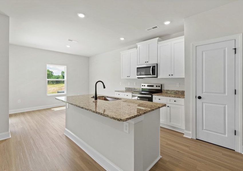 The kitchen has designer wood cabinetry