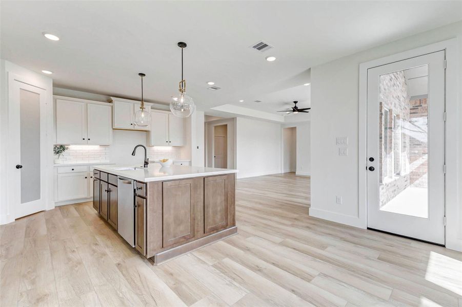 Under cabinet lighting, recessed lighting as well as beautiful gold accented lighting above the island. Under cabinet lighting, recessed lighting as well as beautiful gold accented lighting above the island.