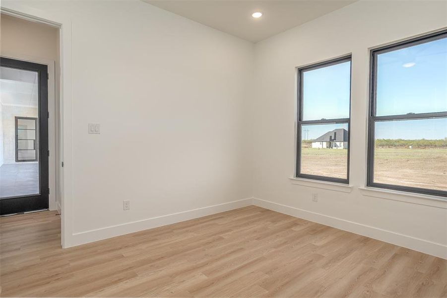 Unfurnished room with light hardwood / wood-style flooring