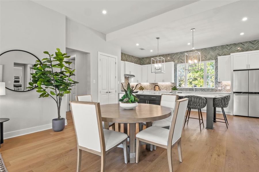 Dining space featuring light wood-style flooring and recessed lightingThe photos shown are of a completed home with the same floor plan and may not reflect the exact finishes, features, or layout of the home currently under construction. Actual details may vary. Please contact the builder or listing agent for specific information about this property.