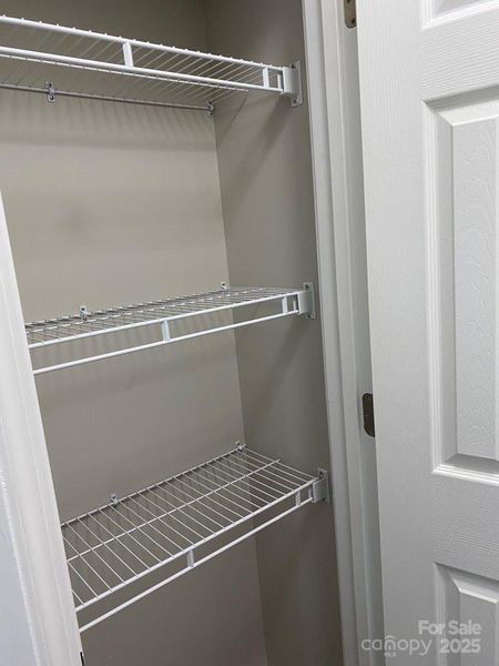 LINEN CLOSET BETWEEN PRIMARY BEDROOM & BATHROOM