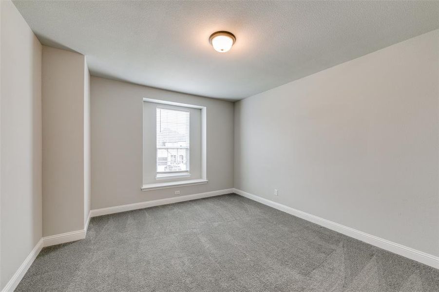 Large upstairs room featuring carpet flooring and large walk in closet and bathroom