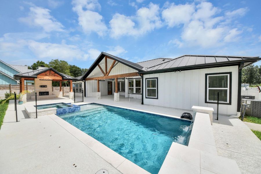 Experience luxury living with a stunning modern pool and spa, complemented by a spacious patio that is ready for a custom outdoor kitchen! Experience luxury living with a stunning modern pool and spa, complemented by a spacious patio that is ready for a custom outdoor kitchen!