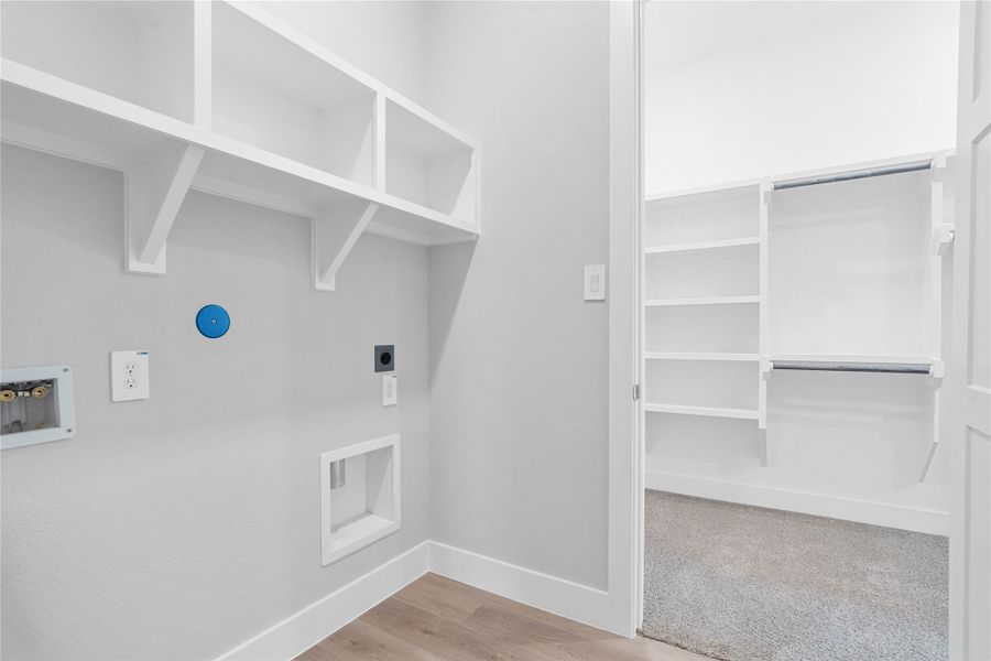 The laundry room has direct access from the primary walk-in closet.