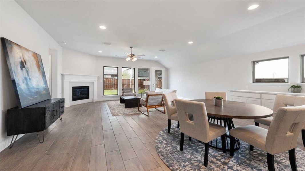 Dining space featuring light wood-type flooring, ceiling fan, and lofted ceiling