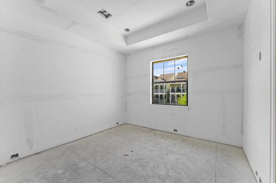Tray ceiling in this secondary bedroom adds an element of architectural style.