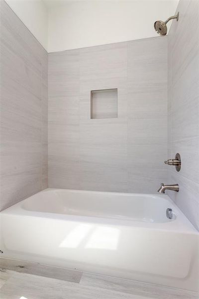 Bathroom featuring tiled shower / bath