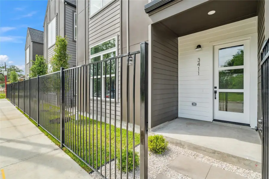 A gated entry and covered porch offer both privacy and a warm welcome, setting the tone for contemporary city living. A gated entry and covered porch offer both privacy and a warm welcome, setting the tone for contemporary city living.