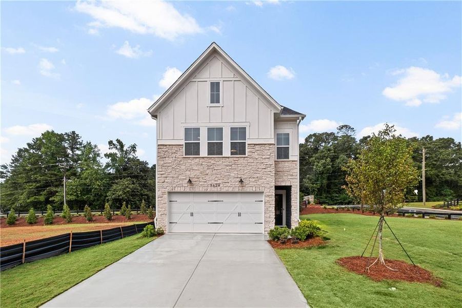 Front exterior of a new home in Adler Springs, Powder Springs, GA, highlighting curb appeal (Image 1). Front exterior of a new home in Adler Springs, Powder Springs, GA, highlighting curb appeal (Image 1).
