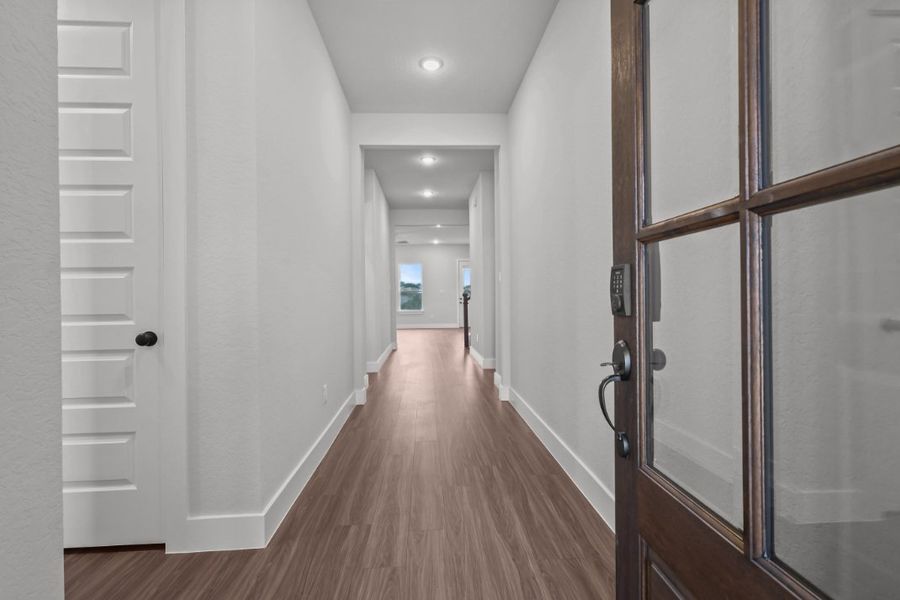 A hallway with white doors. A hallway with white doors.