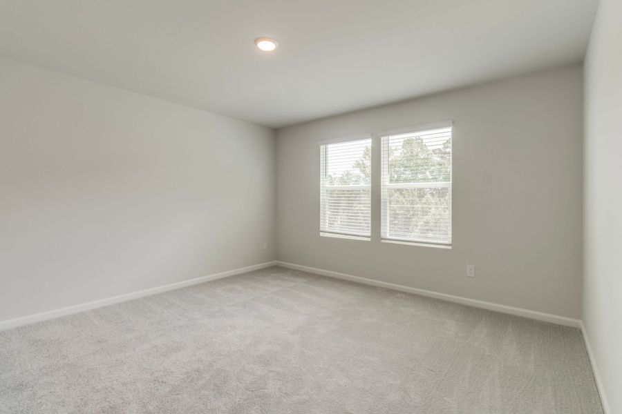 The Owner's Suite is  enhanced by large windows that fill the space with natural light.