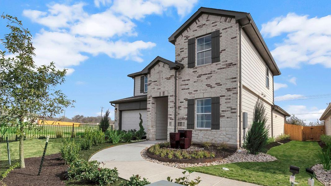 Front exterior of a new home in Carillon, Manor, TX, highlighting curb appeal (Image 22).