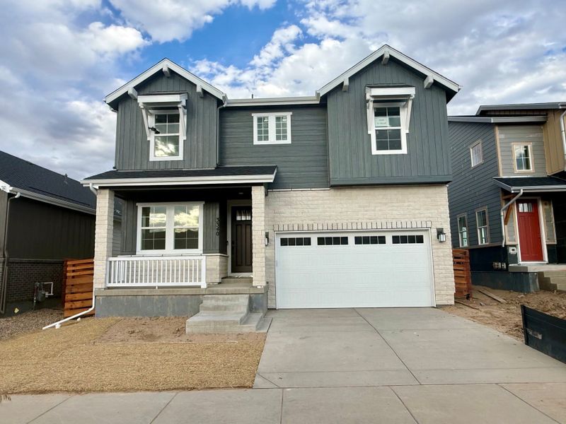 Front exterior of a new home in The Aurora Highlands, Aurora, CO, highlighting curb appeal (Image 1). Front exterior of a new home in The Aurora Highlands, Aurora, CO, highlighting curb appeal (Image 1).