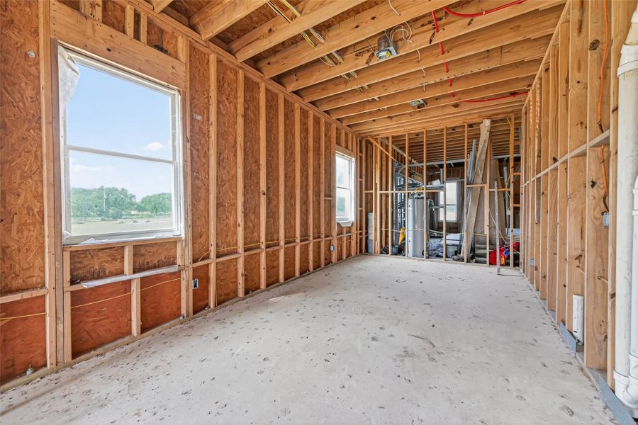 Open unfinished space showcasing framing and build progress.