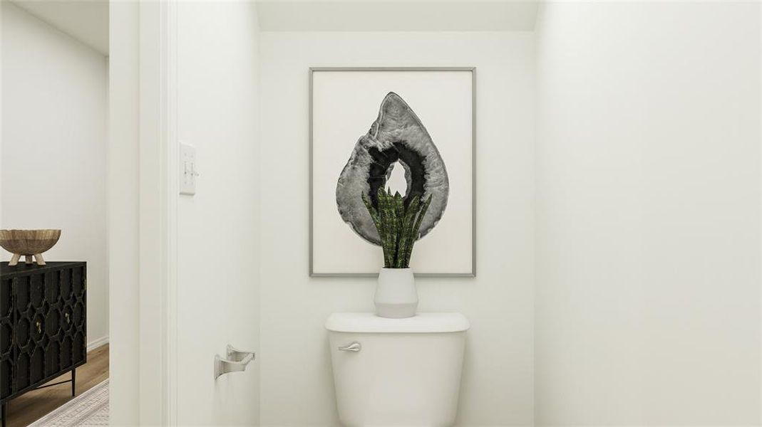 Bathroom featuring wood finished floors and toilet Bathroom featuring wood finished floors and toilet