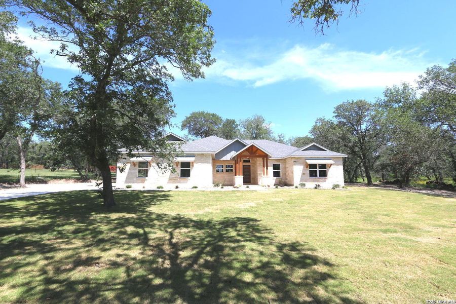 Front exterior of a new home in , La Vernia, TX, highlighting curb appeal (Image 19).