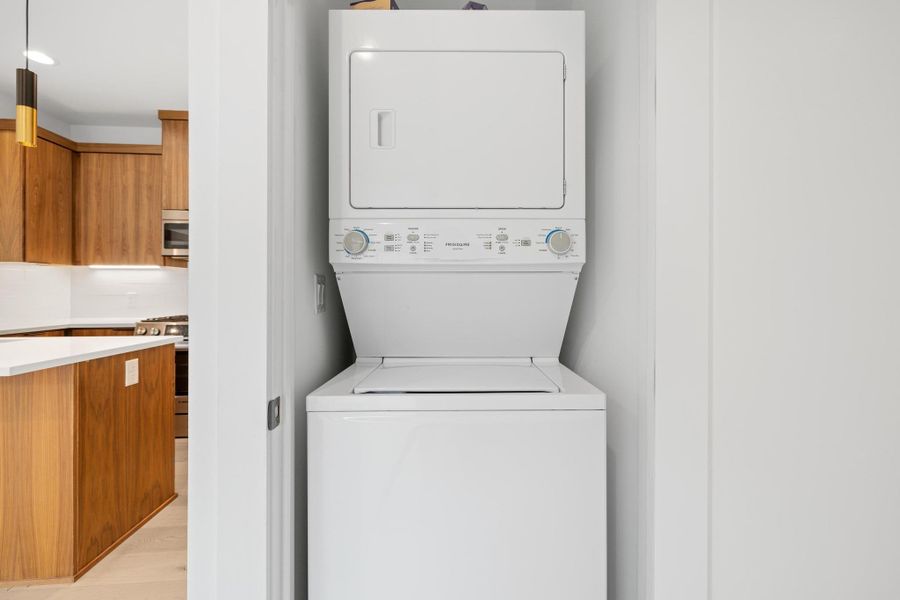 Washroom with stacked washer and clothes dryer Washroom with stacked washer and clothes dryer
