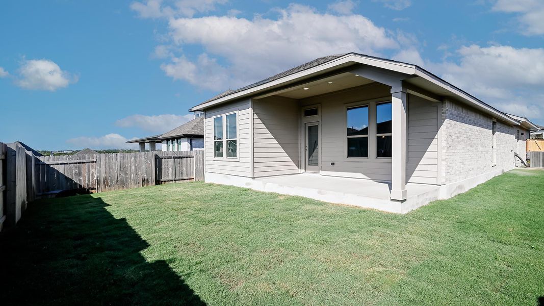 Back of property featuring a patio, a fenced backyard, and brick siding