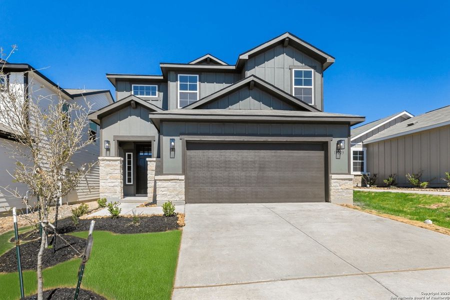 Front exterior of a new home in Veranda Designer, San Antonio, TX, highlighting curb appeal (Image 2). Front exterior of a new home in Veranda Designer, San Antonio, TX, highlighting curb appeal (Image 2).