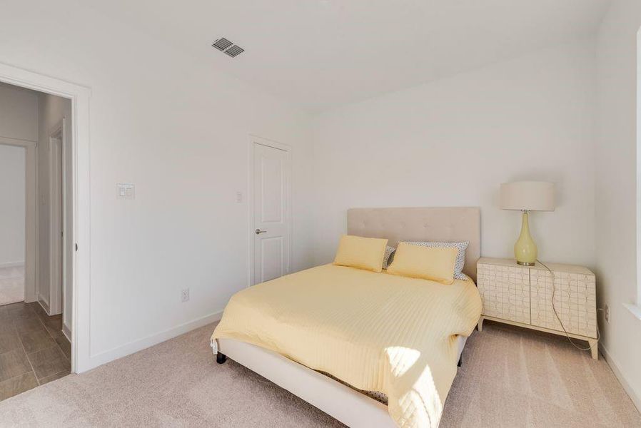 Bedroom featuring carpet and baseboards