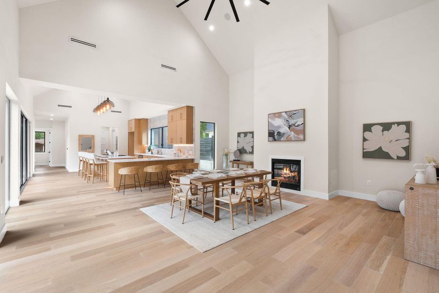 Expansive living space featuring wood-finish flooring and a central fireplace