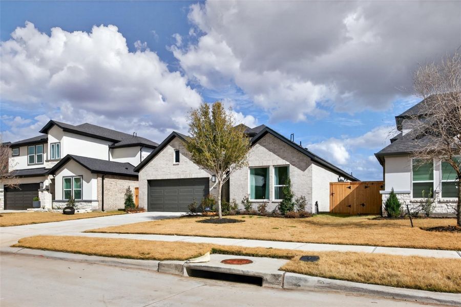 Front exterior of a new home in Trillium, Richmond, TX, highlighting curb appeal (Image 27). Front exterior of a new home in Trillium, Richmond, TX, highlighting curb appeal (Image 27).