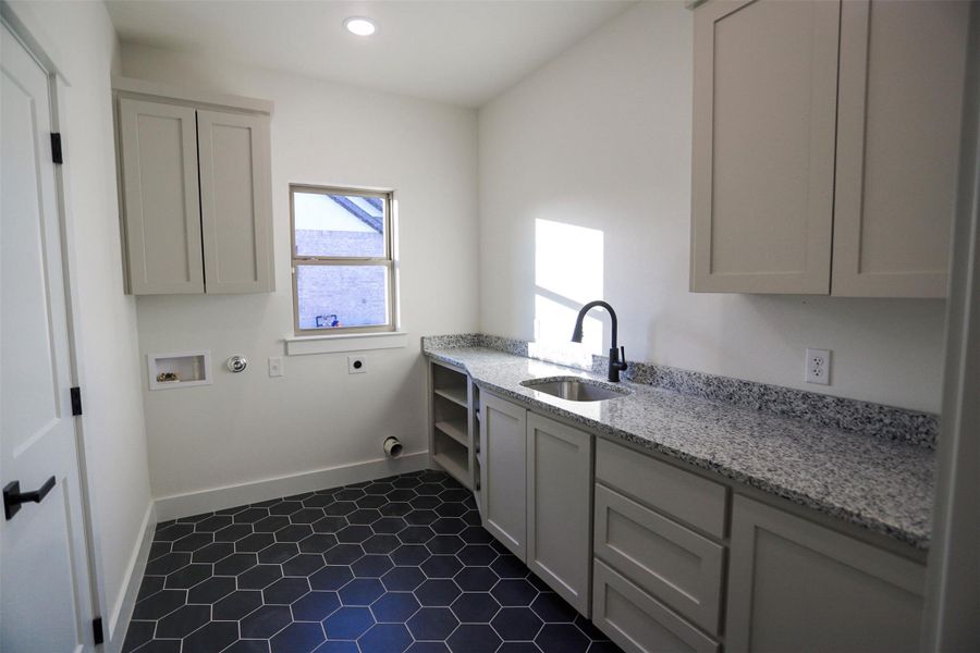 Laundry area featuring cabinet space, hookup for an electric dryer, washer hookup, and hookup for a gas dryer