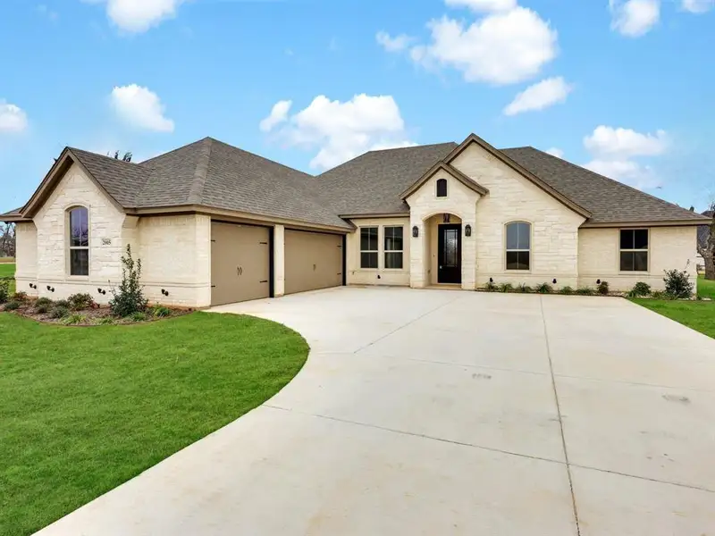 Front exterior of a new home in Pecan Plantation, Granbury, TX, highlighting curb appeal (Image 1). Front exterior of a new home in Pecan Plantation, Granbury, TX, highlighting curb appeal (Image 1).
