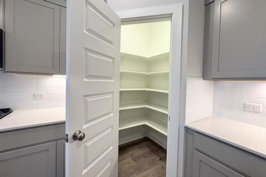 A white cabinet in a kitchen. A white cabinet in a kitchen.