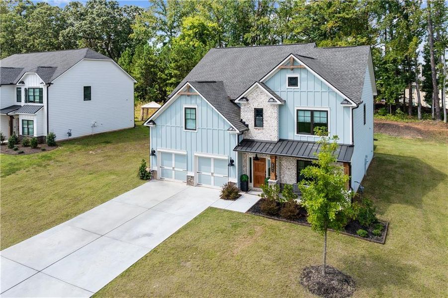 Front exterior of a new home in Springside Reserve, Powder Springs, GA, highlighting curb appeal (Image 28). Front exterior of a new home in Springside Reserve, Powder Springs, GA, highlighting curb appeal (Image 28).