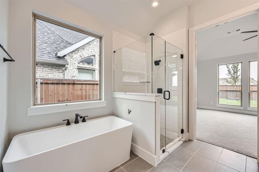 Bathroom with tile patterned flooring, recessed lighting, a shower stall, a soaking tub, and visible vents Bathroom with tile patterned flooring, recessed lighting, a shower stall, a soaking tub, and visible vents