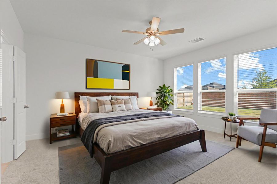 The spacious primary bedroom offers a peaceful retreat with soft natural light, high ceilings, plush carpet, and plenty of room for a cozy sitting area. A relaxing space designed for comfort after a long day! *Virtually Staged*