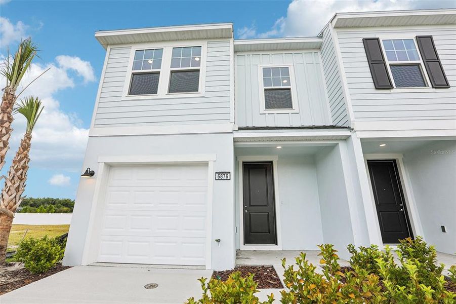 Front exterior of a new home in Twin Oaks, Zephyrhills, FL, highlighting curb appeal (Image 23). Front exterior of a new home in Twin Oaks, Zephyrhills, FL, highlighting curb appeal (Image 23).