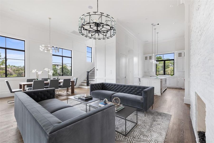 The open concept second floor living areas feature show-stopping fourteen foot ceilings and a designer lighting package. Image from previously completed home in the community.