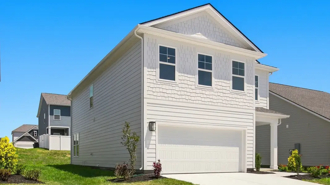 Angled view of home focused on garage side Angled view of home focused on garage side