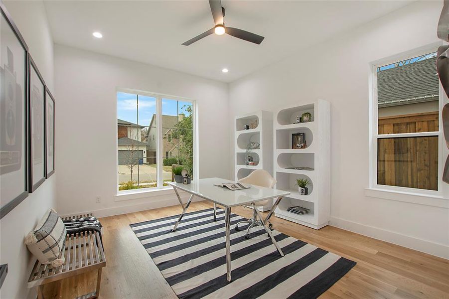 Office area featuring light hardwood / wood-style floors and ceiling fan