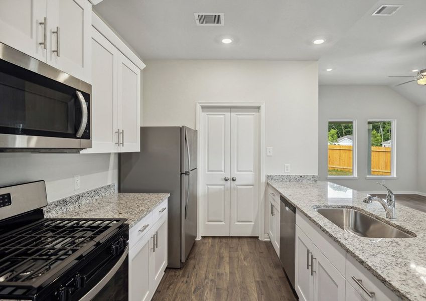 Stainless steel appliances and granite countertops in the kitchen