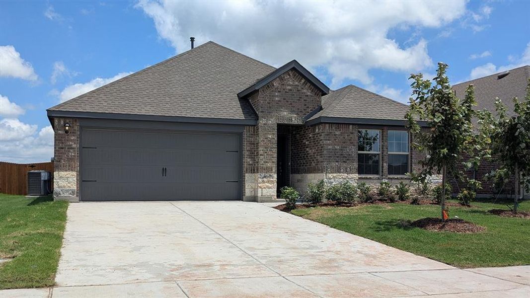 Brick and stone exterior featuring a two-car garage with a concrete driveway Brick and stone exterior featuring a two-car garage with a concrete driveway